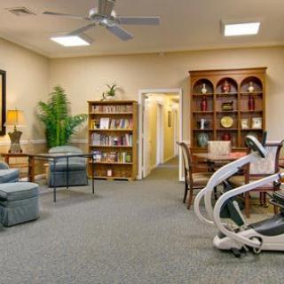 A cozy living room with comfortable seating and well-stocked bookshelves.
