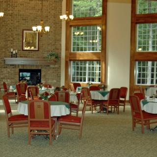 A spacious dining area with large windows and elegant furnishings.