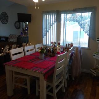 A dining room with a decorated table set for an occasion.