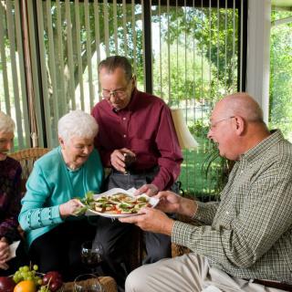 A group of seniors enjoying a meal together indoors.