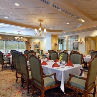 A beautifully set dining room with elegant decor and formal table settings.