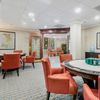 A comfortable lounge area with tables and orange chairs, designed for meetings or social gatherings.
