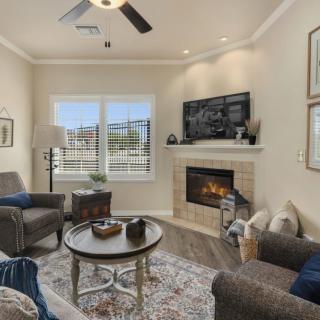 A cozy living room with a fireplace, stylish decor, and comfortable seating.