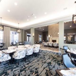 A modern restaurant dining area with stylish furniture and elegant lighting.