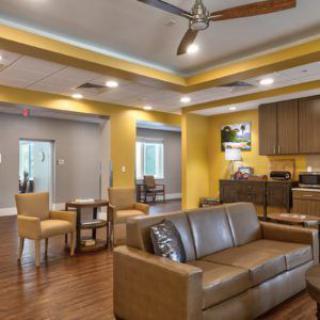 A cozy living space with modern furniture and a small kitchen area.