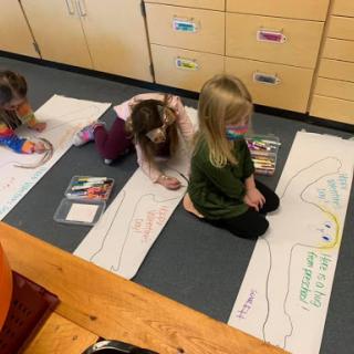 Children engaged in a creative learning activity in the classroom.