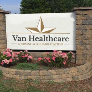 Entrance sign for Van Healthcare Nursing & Rehabilitation surrounded by flowers.