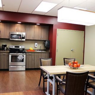 A modern kitchen and dining area featuring sleek appliances and a comfortable table setup.