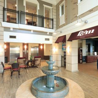 Elegant hotel lobby with a central fountain and comfortable seating.