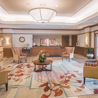 A spacious hotel lobby with comfortable seating and elegant decor.