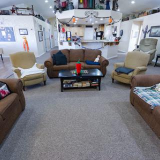 A cozy living room with a warm atmosphere featuring comfortable sofas and a coffee table.