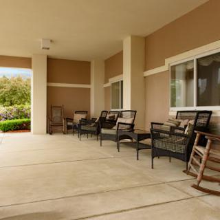 A serene outdoor patio area equipped with comfortable chairs, perfect for relaxation.