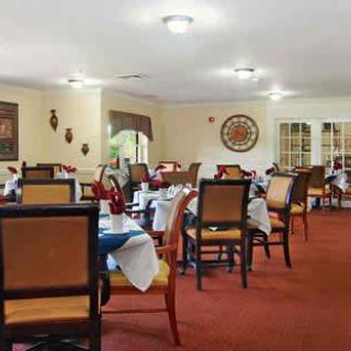 A cozy restaurant dining room with neatly arranged tables and chairs.