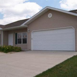 A single-story house with a garage and well-maintained front yard.