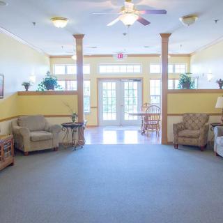 A spacious and brightly lit lobby area with comfortable seating arrangements.