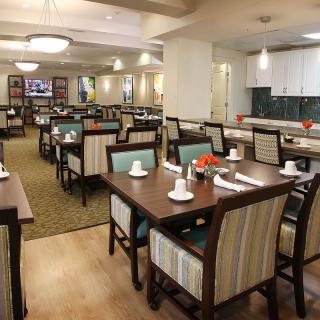 A modern restaurant dining area with neatly arranged tables and chairs, ready for guests.
