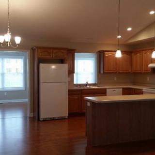 Spacious kitchen and dining area with wooden cabinets and an island counter.