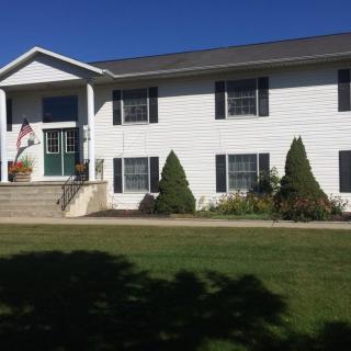 A suburban house with a well-maintained lawn on a sunny day.