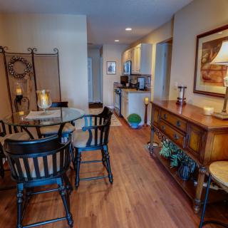 A cozy dining area with warm wooden flooring and inviting ambiance.