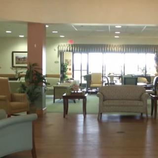 A spacious lobby area featuring comfortable seating and decorative plants.