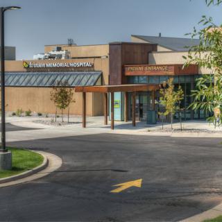 A modern hospital building with a clean entrance and surrounding landscaping.