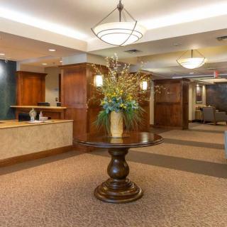 A well-decorated lobby area featuring a central table with a floral arrangement.