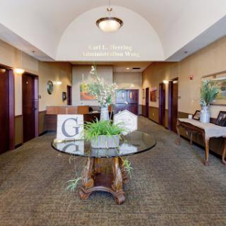 A welcoming lobby featuring elegant furnishings and decorative plants.