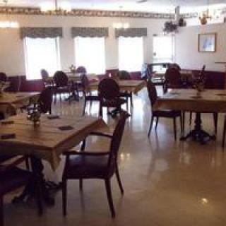 A spacious dining area with neatly arranged tables and chairs.