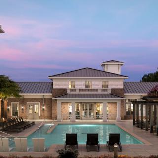 A luxurious residence with a swimming pool at sunset.