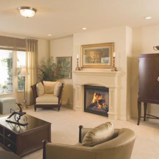 A cozy living room featuring a fireplace, armchairs, and elegant decor.