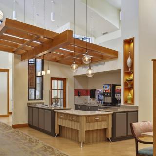 A stylish modern kitchen with wood accents and pendant lighting.