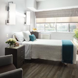A cozy and modern bedroom featuring a comfortable bed, stylish furniture, and ample natural light.