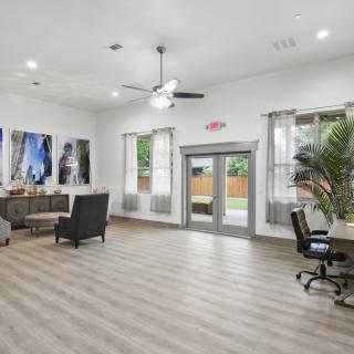 A spacious, modern interior with seating and large windows.