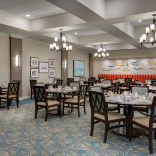 A well-decorated restaurant dining room with neatly arranged tables and chairs.