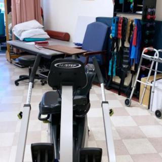 A gym setup featuring exercise equipment and rehabilitation tools.