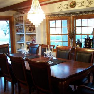 A beautifully arranged dining room featuring a wooden table, elegant chairs, and a stylish chandelier, perfect for family gatherings.
