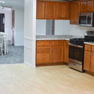 A modern kitchen with wood cabinets and stainless steel appliances.