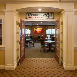 Entrance to a restaurant with visible seating and signage.