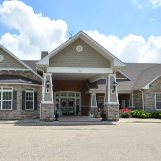 A large residential-style building with a welcoming entrance and stone faade.