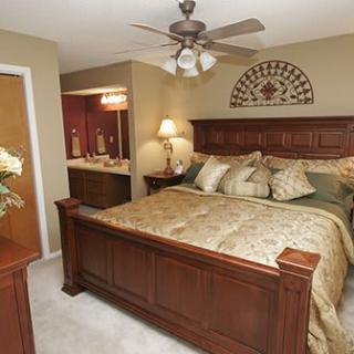 A cozy bedroom with a large wooden bed and elegant decor.