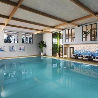 A luxurious indoor swimming pool with modern design elements and a relaxing ambiance.