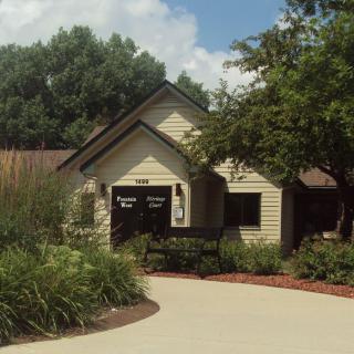 A charming house surrounded by lush greenery and a neatly maintained garden.