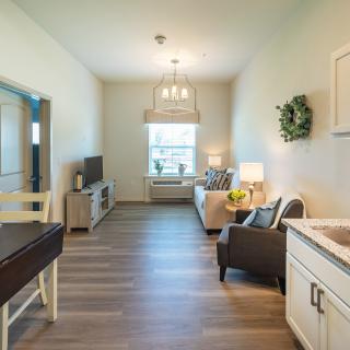A cozy living room with modern decor and wooden flooring.