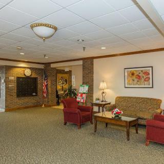 A cozy lobby area featuring comfortable seating and decorative elements.