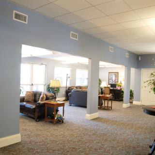 A cozy and bright living area with sofas and blue walls.