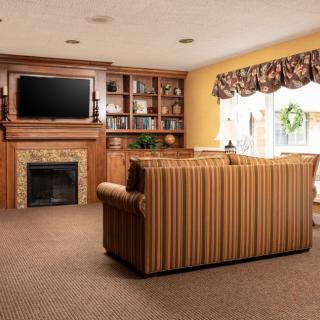 Cozy living room with a couch, fireplace, and television.