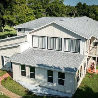 Aerial view of a suburban house with a large yard.