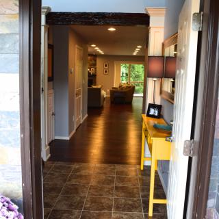 A welcoming view into a cozy home with an open door leading to a hallway and living room area.