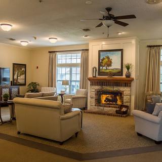 A cozy living room with a fireplace, comfortable seating, and tasteful decor.