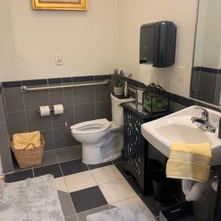 A neatly organized bathroom with modern fixtures and decor.